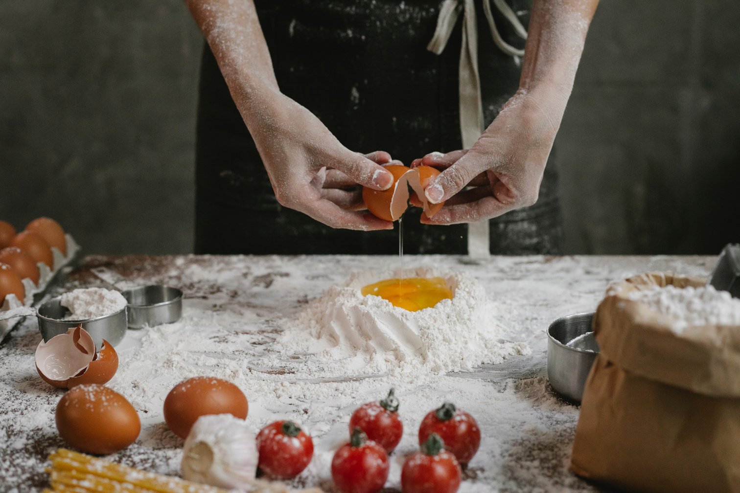 Cook adding egg to flour and oil while cooking